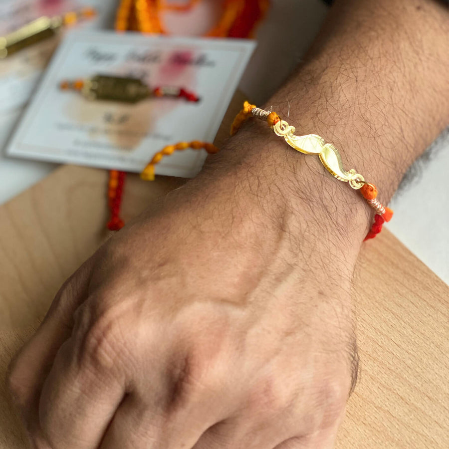 Handcrafted Golden Acrylic Rakhi With Roli Chawal 2 - Bracelet worn on wrist