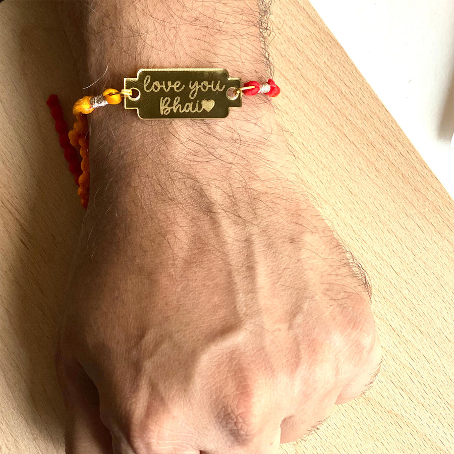 Handcrafted Golden Acrylic Rakhi With Roli Chawal 5 - Worn on wrist close-up