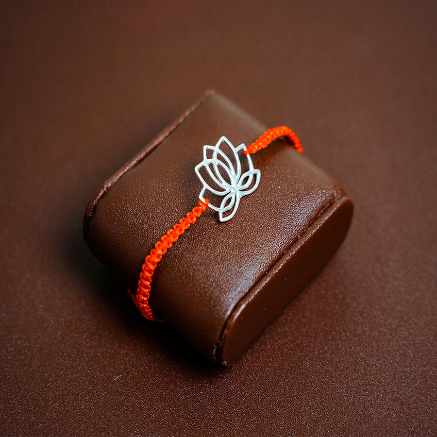 Handcrafted Silver Motif Adjustable Rakhi With Rice Roli 3 - Bracelet on Display Cushion