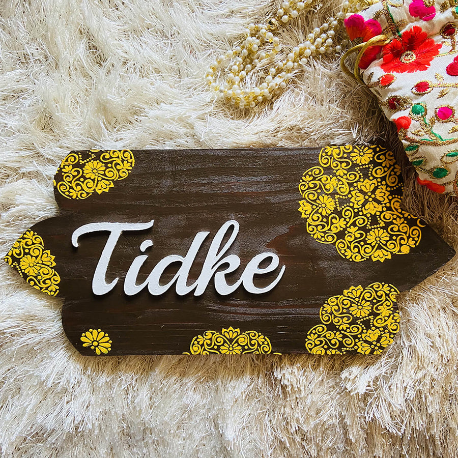 Handcrafted Personalized Curvy Pinewood Textured Name Plate - Top View on Textured Surface