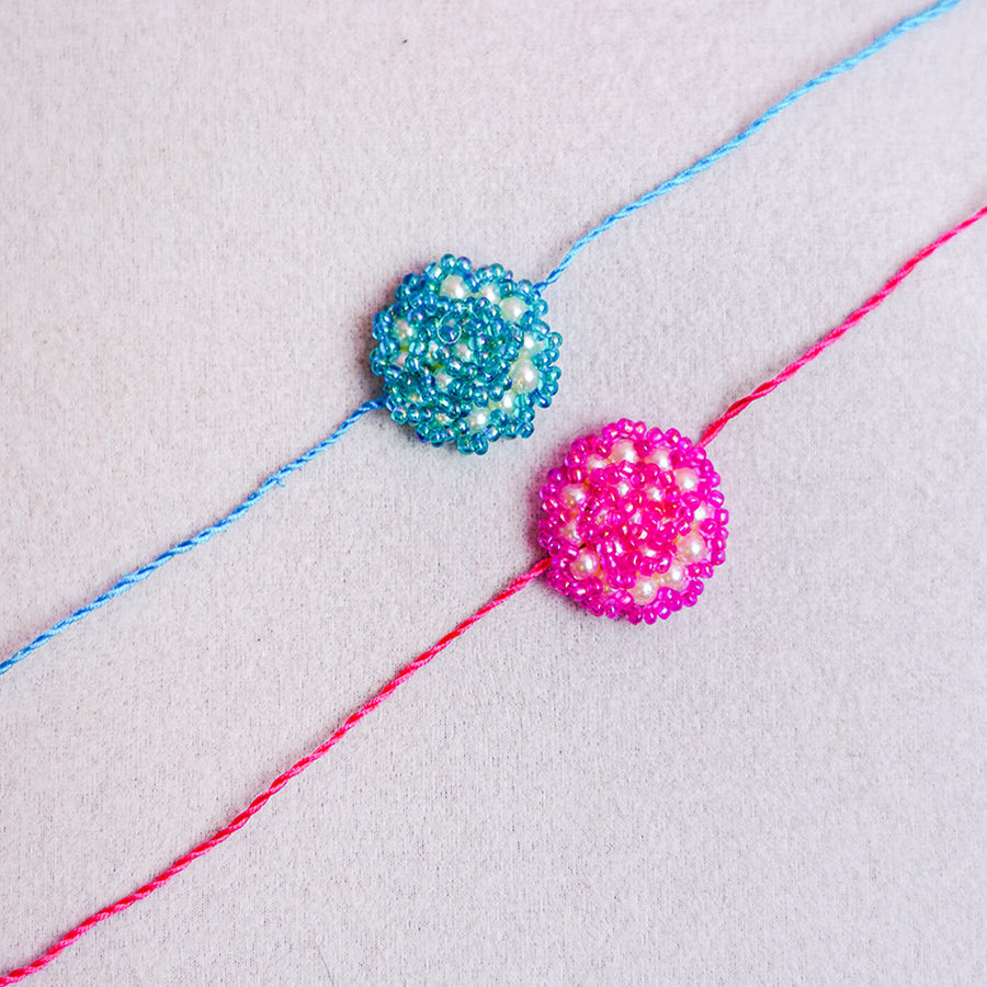 Handcrafted Rose Glass Beads Rakhi Set Of 2 - Close-up of Two Rakhis