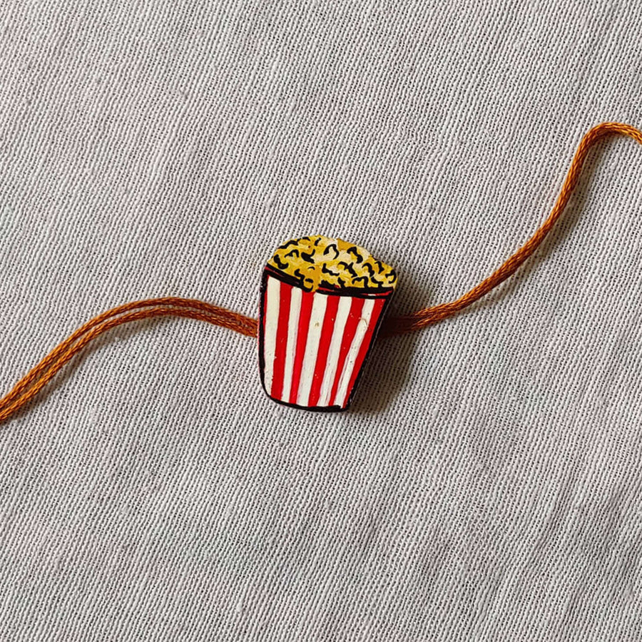 Handpainted Quirky Wooden Rakhi With Roli Chawal 5 - Close-up on Popcorn Rakhi