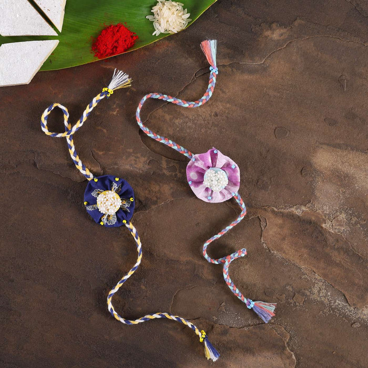 Handmade Beaded Round Pearl Rakhi With Roli Chawal Set Of 2 - Flat Lay with Traditional Items