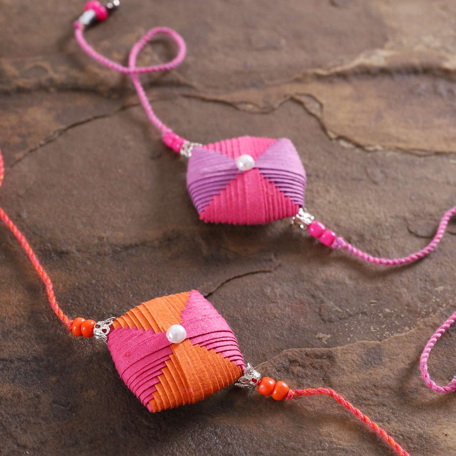 Handmade Beaded Paper Cushion Rakhi With Roli Chawal Set Of 2 - Close-up of Decorative Bands