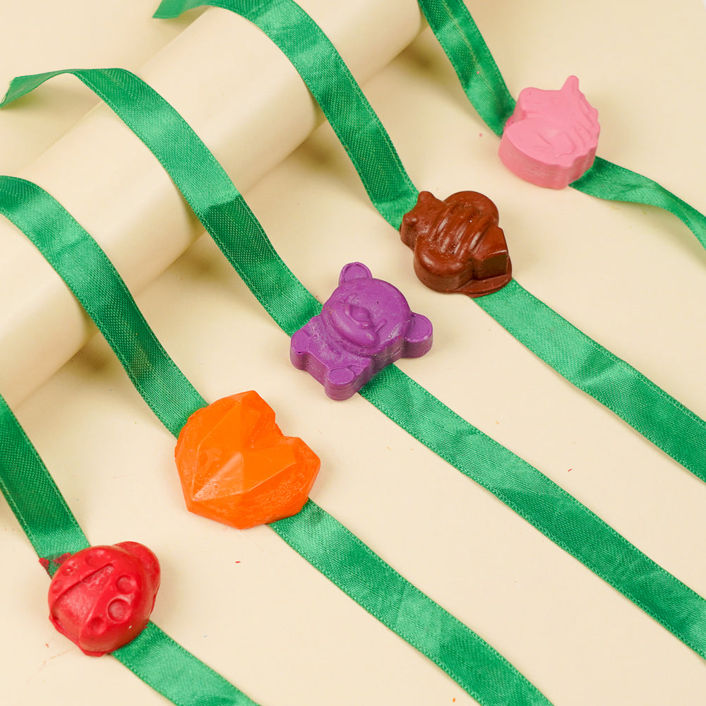 Reusable Non Toxic Girls Theme Wax Kids Rakhi Set Of 5 - Side View Showing Charm Shapes on Ribbon