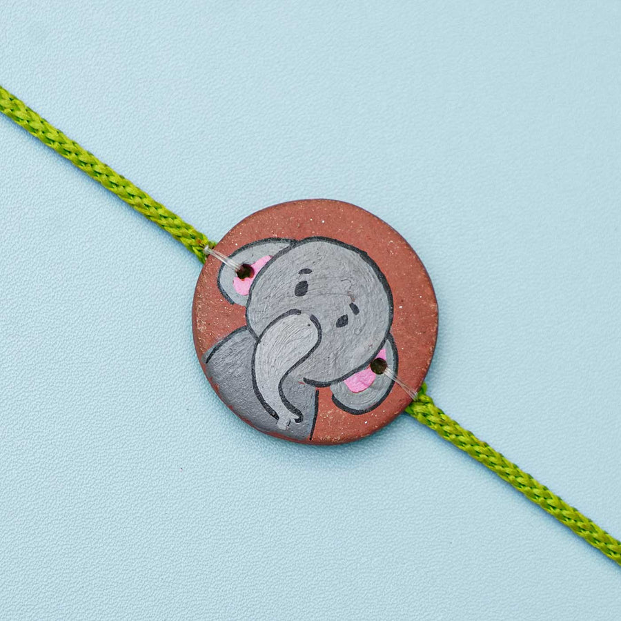 Hand Painted Elephant2 Terracotta Rakhi With Roli Chawal For Kids Copy - Top View Close-up