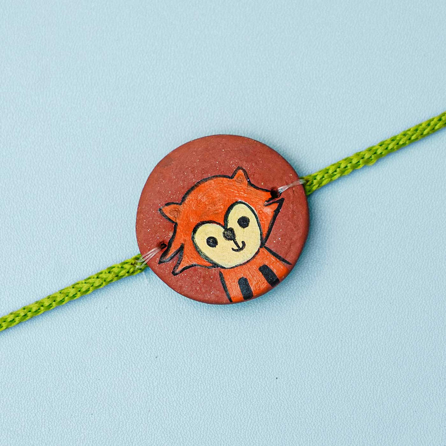 Hand Painted Fox Terracotta Rakhi With Roli Chawal For Kids - Close-up of Rakhi center piece