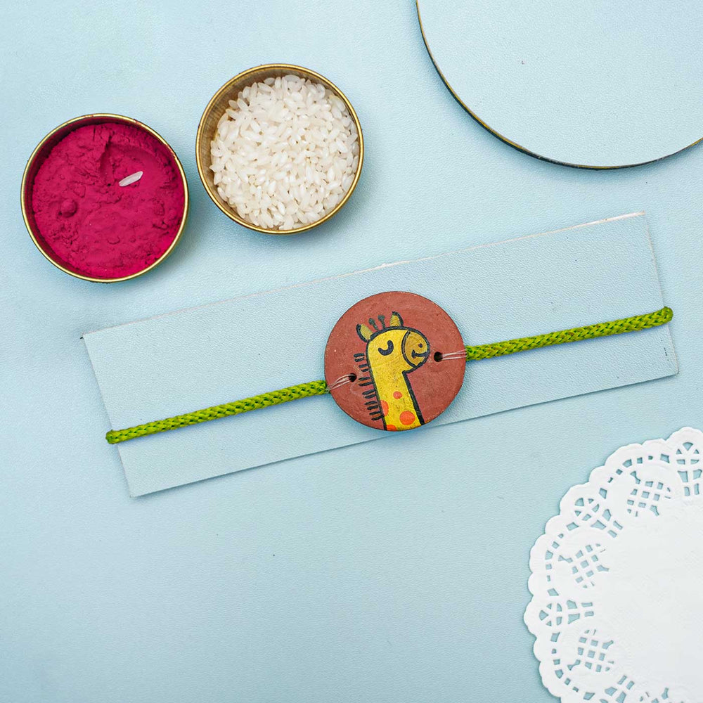 Personalized Animal Theme Terracotta Rakhi With Roli Chawal For Kids 6 - Flat Lay Display with Ritual Items