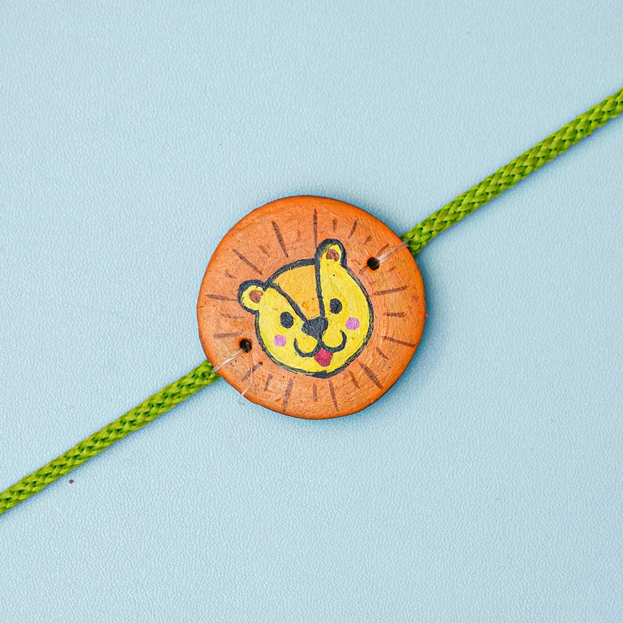 Hand Painted Panther Terracotta Rakhi With Roli Chawal For Kids - Close-up Front View