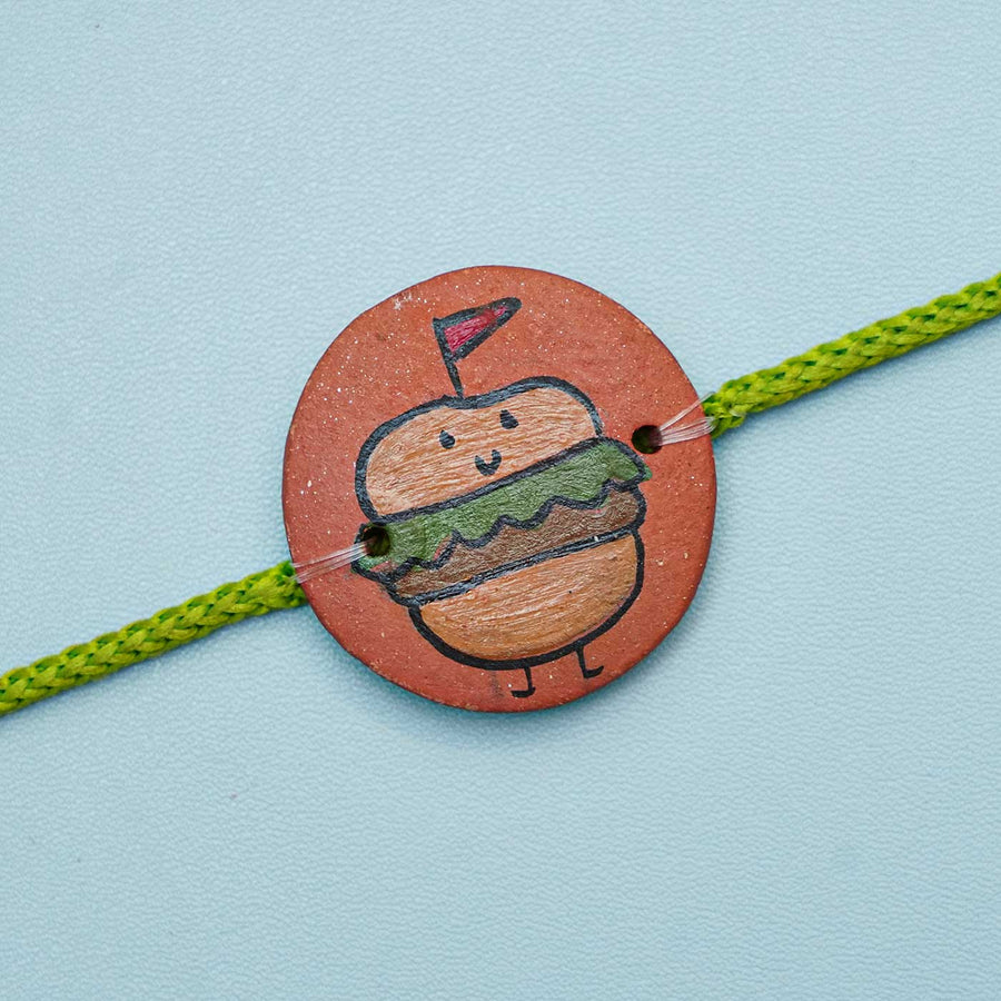 Personalized Food Theme Terracotta Rakhi With Roli Chawal 3 - Front View Close-up