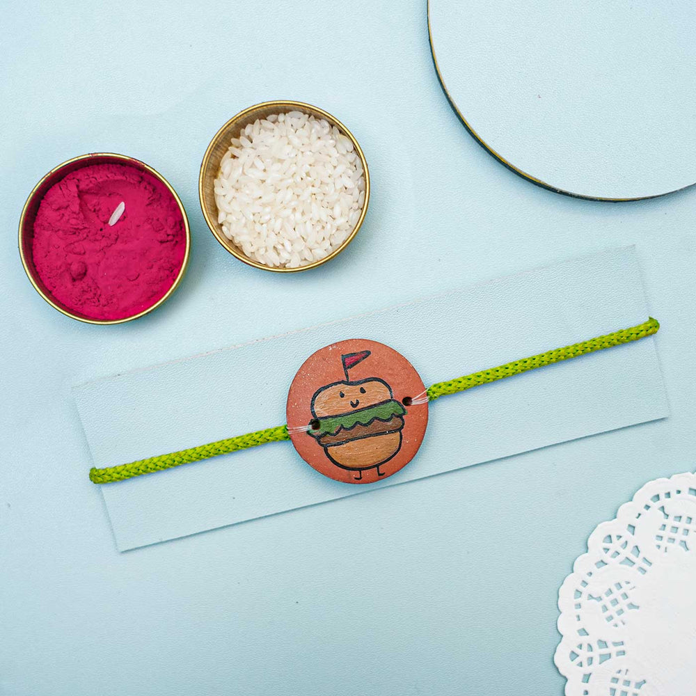 Personalized Food Theme Terracotta Rakhi With Roli Chawal 3 - Styled Product Display with Accessories