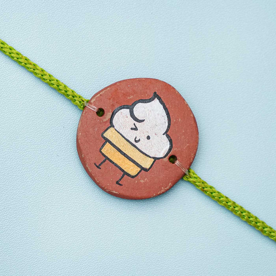 Hand Painted Ice Cream Theme Terracotta Rakhi With Roli Chawal - Close-up of Circular Bracelet Charm