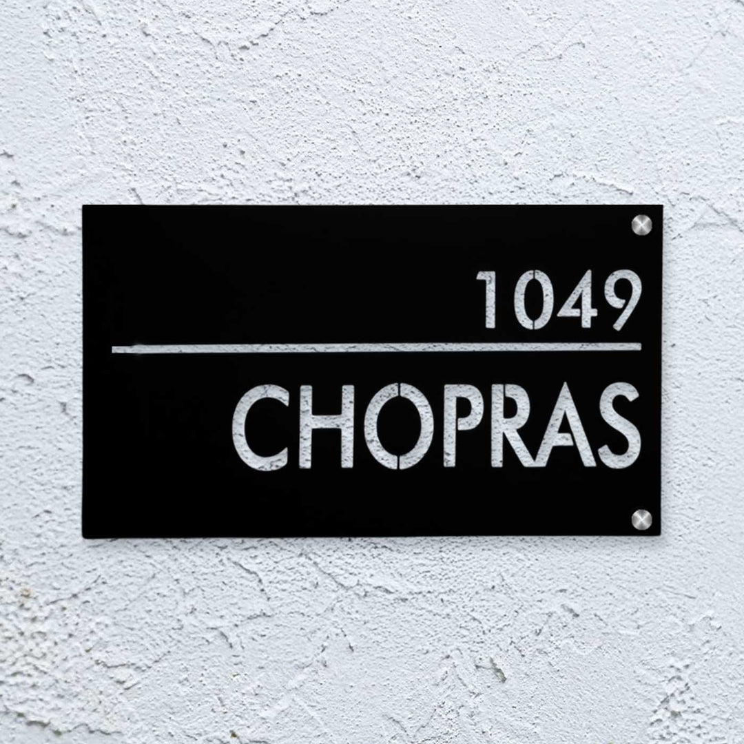 Personalized Waterproof Black Laser Cut Metal Led Name Plate - Mounted on textured wall close-up