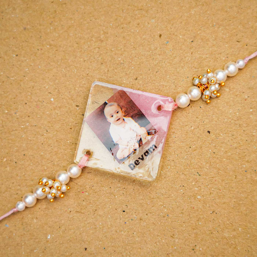 Personalized Reusable Resin Kids Rakhi With Roli Chawal For Newborns - Close-up of personalized photo rakhi