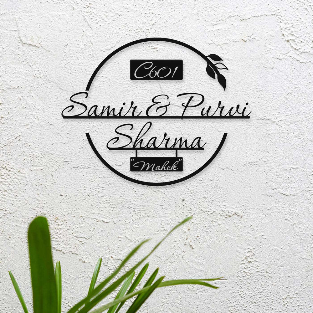 Personalized Laser Cut Round Leaf Design Steel Name Plate - Mounted on textured wall close-up
