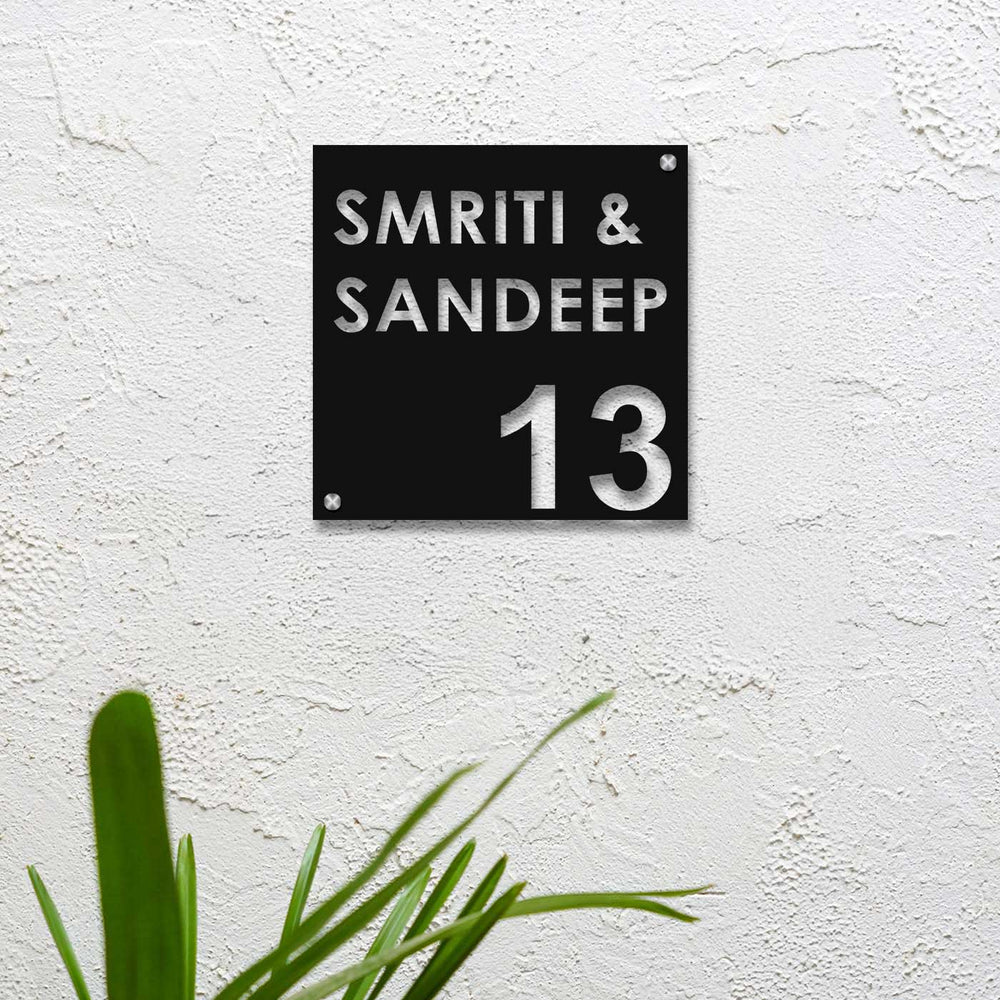 Personalized Laser Cut Square Shaped Steel Name Plate - Front View Mounted on Textured Wall