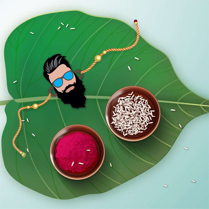 Handmade Printed Dashing Bhai Wooden Rudraksha Rakhi With Roli Chawal - Flat Lay on Leaf with Accessories