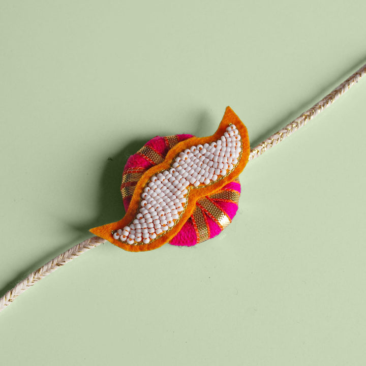 Handmade Reusable White Mustach Felt Rakhi For Brother - Close-up on Flat Surface