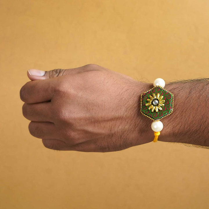 Handmade Green Hexagon Fabric And Mdf Rakhi With Roli Chawal - Worn on Wrist Display