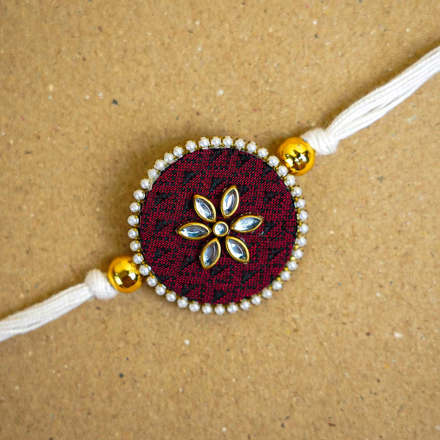 Handmade Brown Round Fabric And Mdf Rakhi With Roli Chawal - Close-up of Rakhi decoration