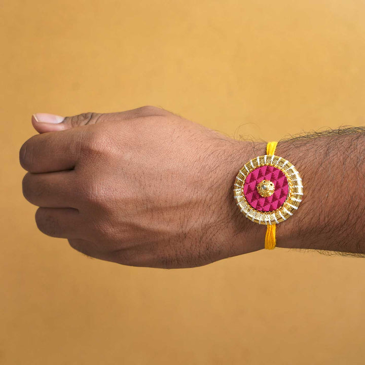 Handmade Maroon And Yellow Round Fabric And Mdf Rakhi With Roli Chawal - Rakhi Worn on Wrist