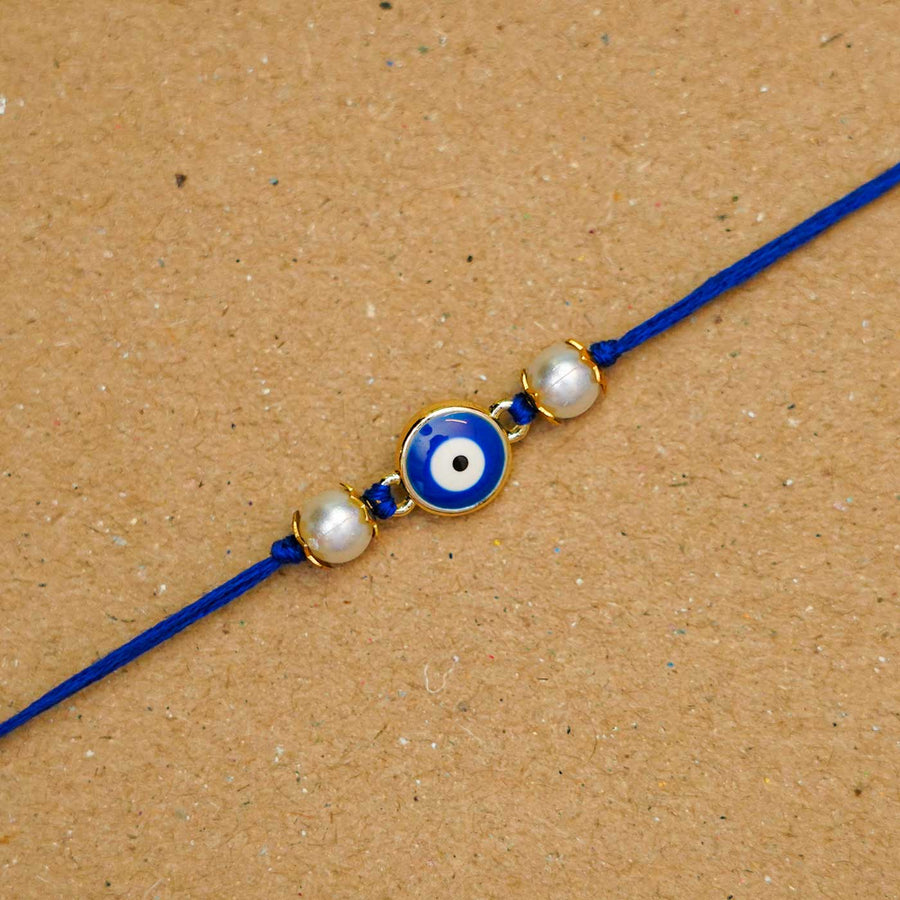 Reusable Resin Evil Eye Rakhi With Roli Chawal For Brother - Close-up of Central Charm