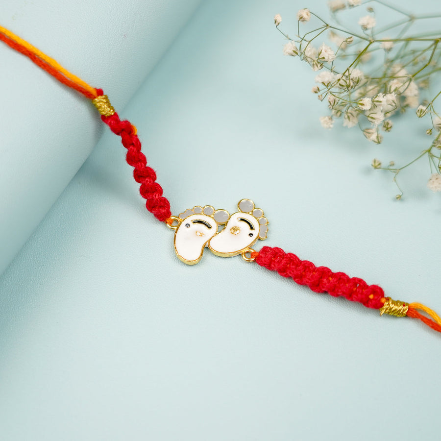 Handmade Macrame Baby Feet Theme Metal Rakhi With Roli Chawal - Close-up of Centerpiece Detail