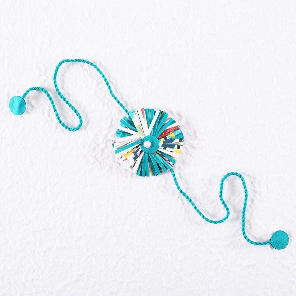 Handmade Ecofriendly Blue Recycled Paper Rakhi With Roli Chawal - Flat Lay on White Background