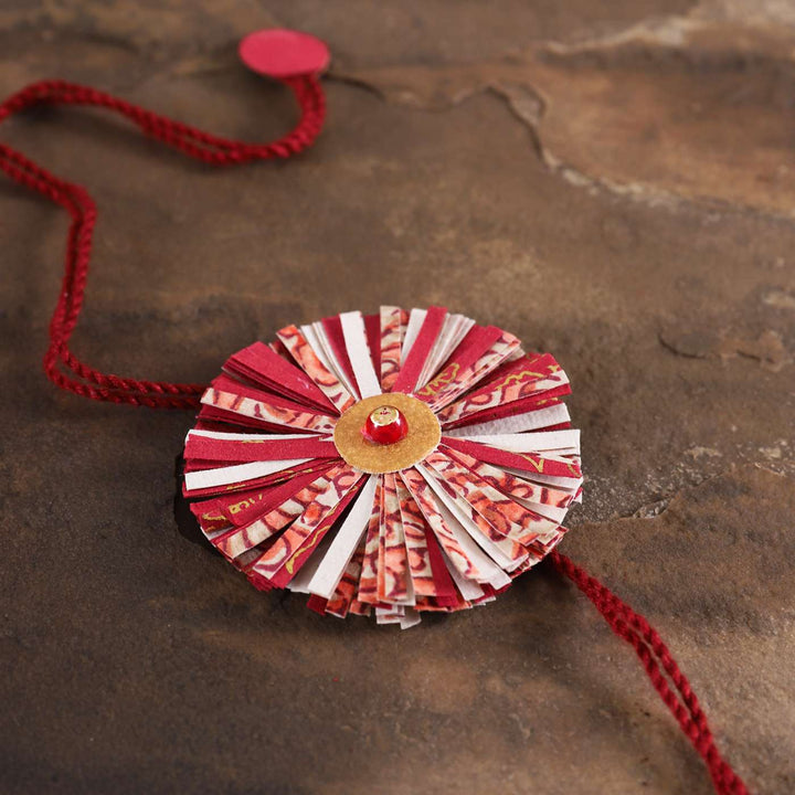 Handmade Ecofriendly Red Recycled Paper Rakhi With Roli Chawal - Close-up Detail View
