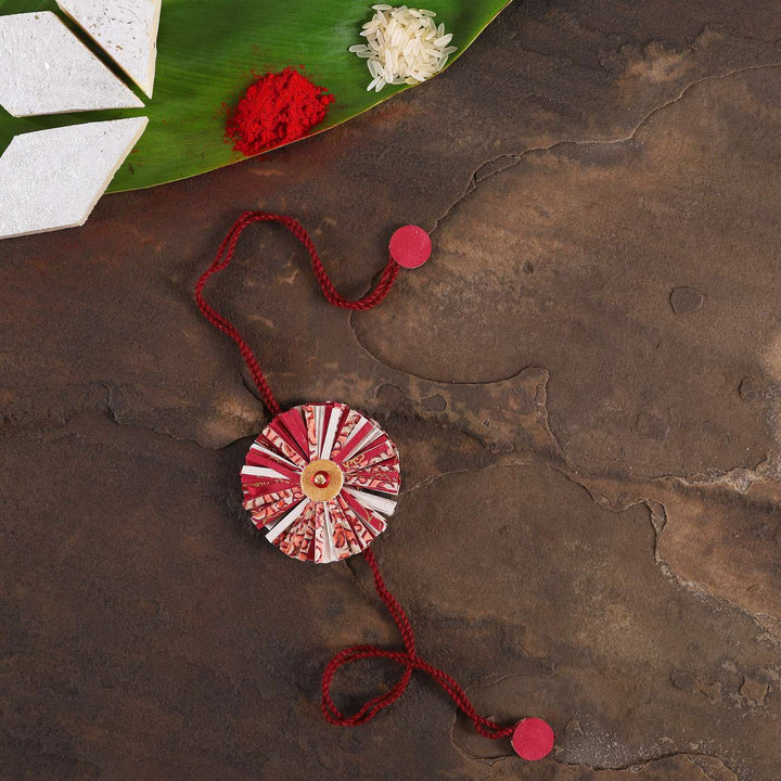 Handmade Ecofriendly Red Recycled Paper Rakhi With Roli Chawal - Styled Flat Lay with Cultural Items