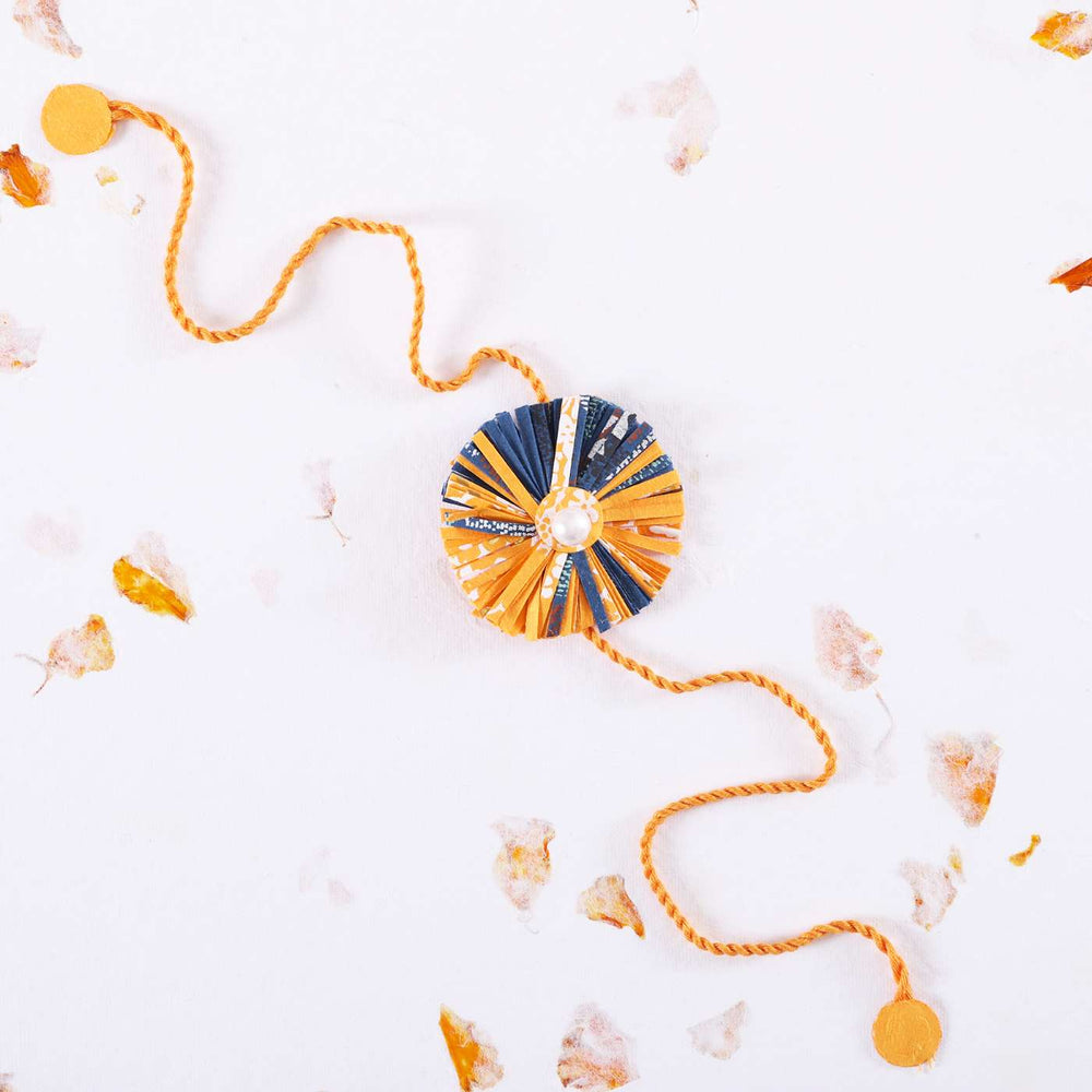 Handmade Ecofriendly Yellow Recycled Paper Rakhi With Roli Chawal - Full View on White Background
