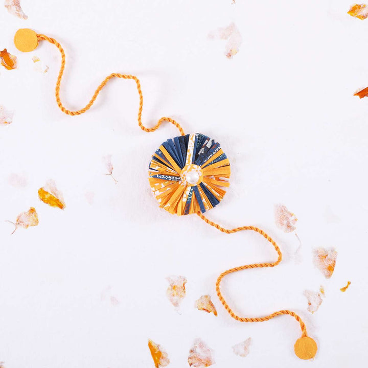 Handmade Ecofriendly Yellow Recycled Paper Rakhi With Roli Chawal - Full View on White Background