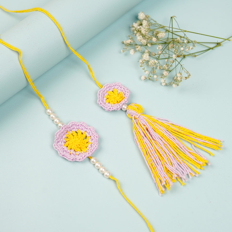 Handmade Crochet Yellow Floral And Beads Rakhi With Roli Chawal For Bhaiya Bhabhi And Kids - Pair Laid Out Flat