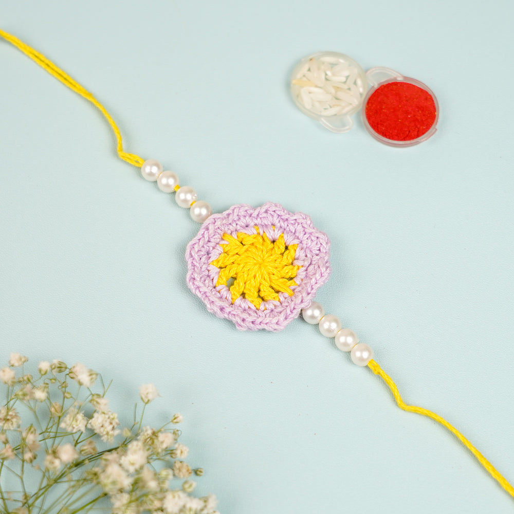 Handmade Crochet Yellow Floral And Beads Rakhi With Roli Chawal For Bhaiya Bhabhi And Kids - Close-up with Accessories