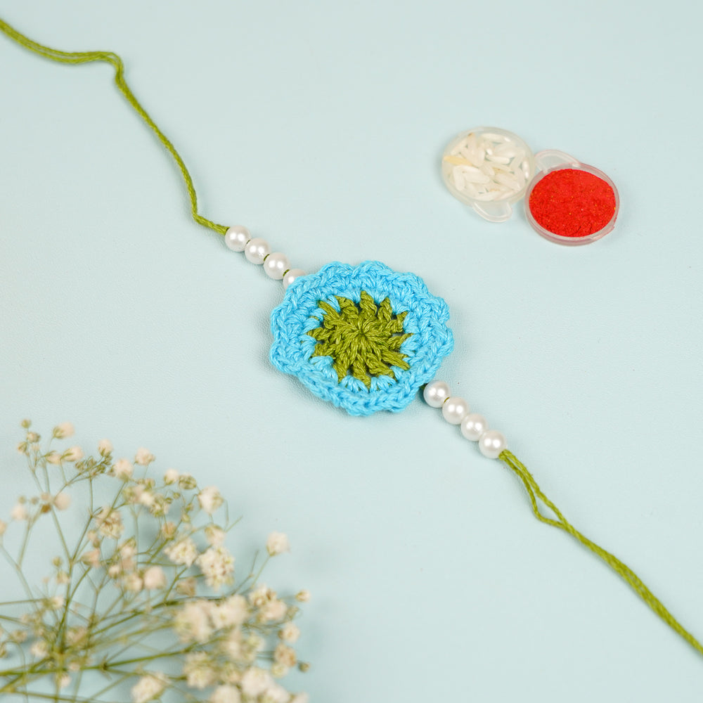 Handmade Crochet Blue Floral And Beads Rakhi With Roli Chawal For Bhaiya Bhabhi And Kids - Close-up of Flower Center