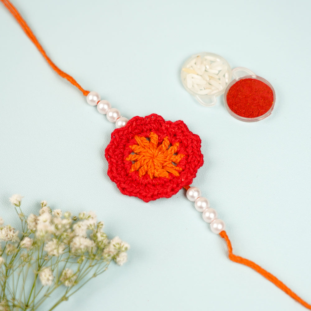Handmade Crochet Red Floral And Beads Rakhi With Roli Chawal For Bhaiya Bhabhi And Kids - Close-up of Crochet Flower and Beads