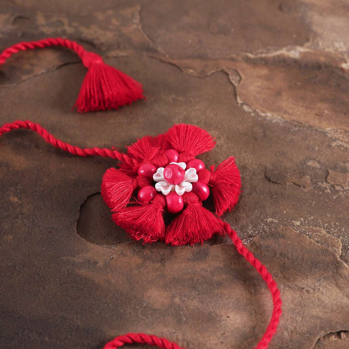 Handmade Beaded Tassel Flower Cotton Rakhi With Roli Chawal 1 - Close-up of floral tassel centerpiece