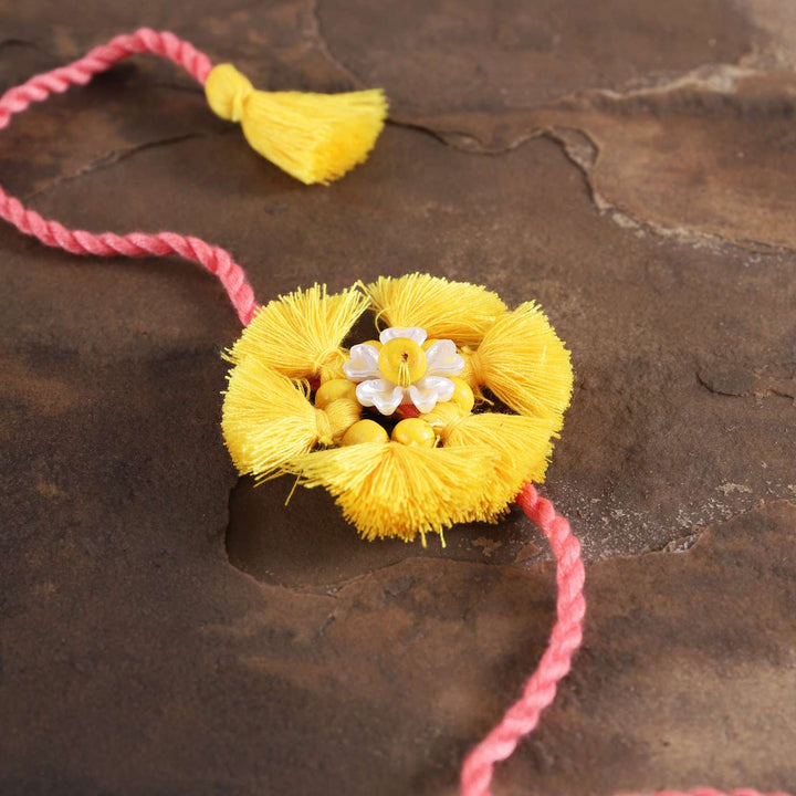 Handmade Beaded Tassel Flower Cotton Rakhi With Roli Chawal - Close-up of central floral design