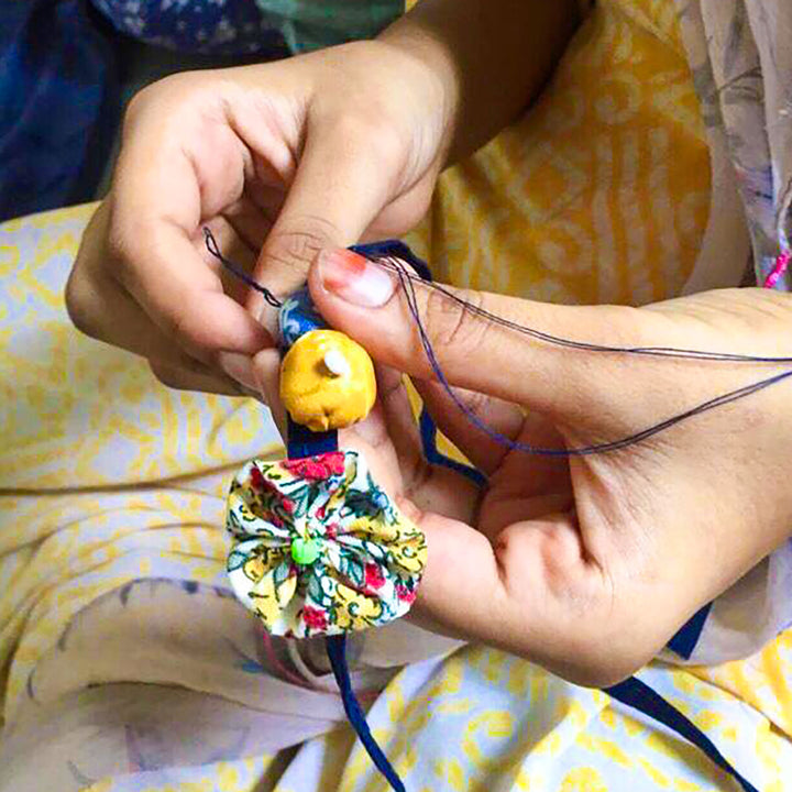 Handmade Beaded Flower And Button Design Upcycled Fabric Rakhi With Roli Chawal For Brother - Handcrafting Process