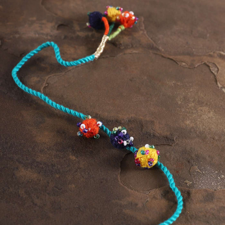 Handmade Beaded Light Blue Dori Rakhi With Roli Chawal - Close-up on beaded detail