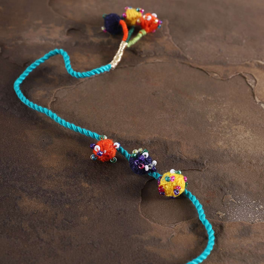 Handmade Beaded Light Blue Dori Rakhi With Roli Chawal - Close-up on beaded detail