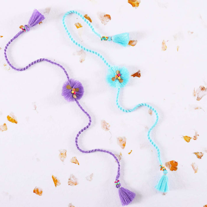 Handmade Threads Cotton Rakhi With Roli Chawal Set Of 2 - Styled on White Marble Background