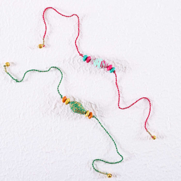 Handmade Beaded Paper Tubular Rakhi With Roli Chawal Set Of 2 - Rakhi Pair on White Background