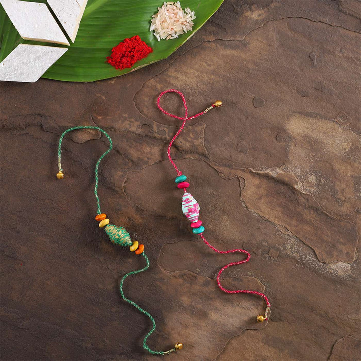 Handmade Beaded Paper Tubular Rakhi With Roli Chawal Set Of 2 - Rakhi Pair with Rice and Red Powder