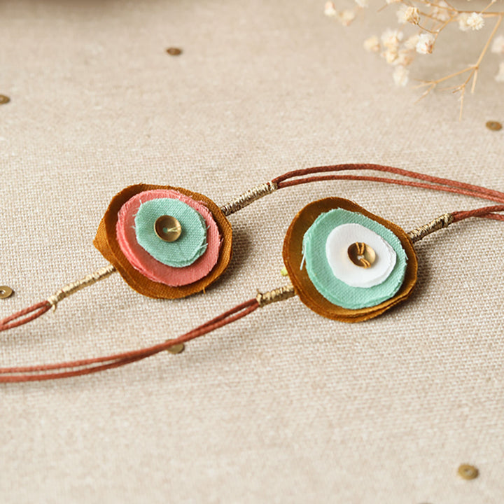 Handmade Reusable Layered Petal And Ghungroo Upcycled Fabric Rakhi With Roli Chawal For Brother Set Of 2 - Close-up of Fabric Detail