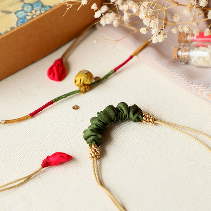 Handmade Reusable Pod And Gathered Upcycled Fabric Rakhi With Roli Chawal For Brother Set Of 2 - Close-up of ruched bracelet detail