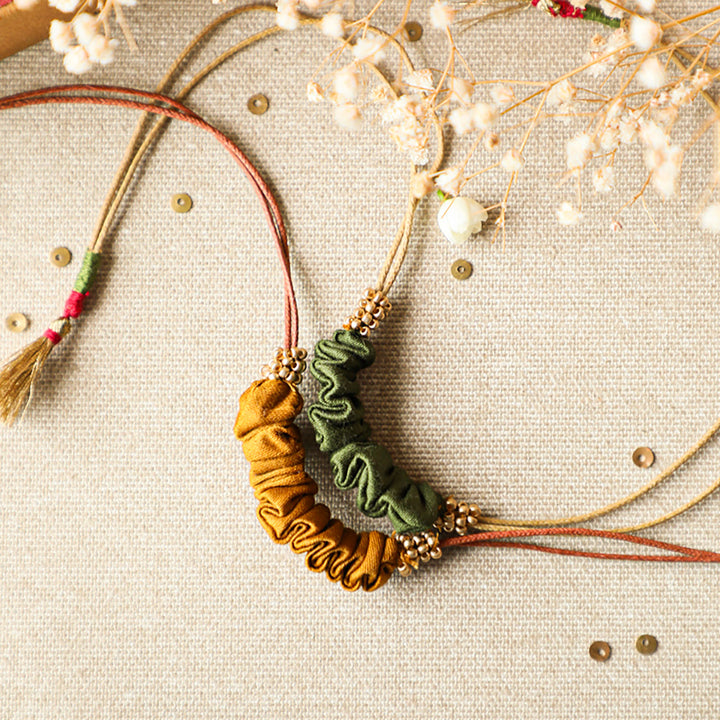 Handmade Reusable Gold Beads And Gathered Upcycled Fabric Rakhi With Roli Chawal For Brother Set Of 2 - Close-up of necklace details