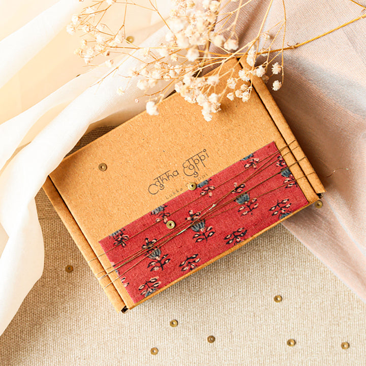 Handmade Reusable Gold Beads And Gathered Upcycled Fabric Rakhi With Roli Chawal For Brother Set Of 2 - Packaging box with decorative fabric