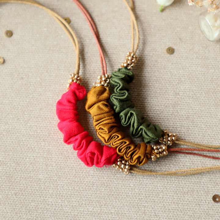 Handmade Reusable Gold Beads And Gathered Upcycled Fabric Rakhi With Roli Chawal For Brother Set Of 3 - Close-up of Necklace Details