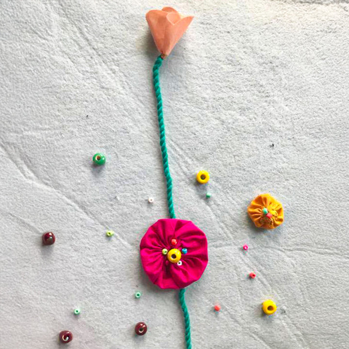 Handmade Beaded Yo Yo Flower Design Upcycled Fabric Rakhi With Roli Chawal For Brother - Decorative arrangement top view